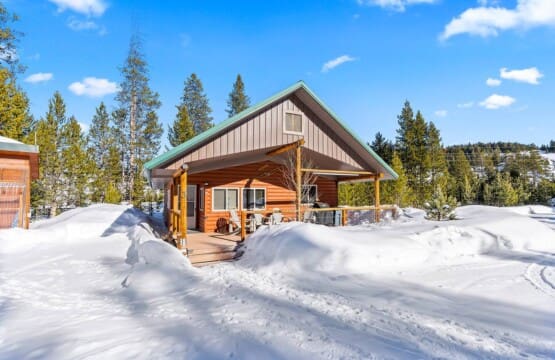 Valley Creek Cabin surrounded by deep snow during winter in Stanley, Idaho.