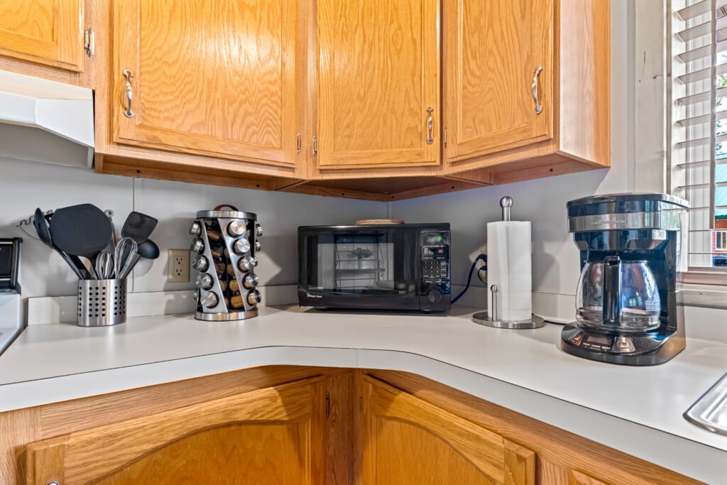 Kitchen coffee station at Ponderosa Pine Cabin with coffee maker, microwave and supplies.