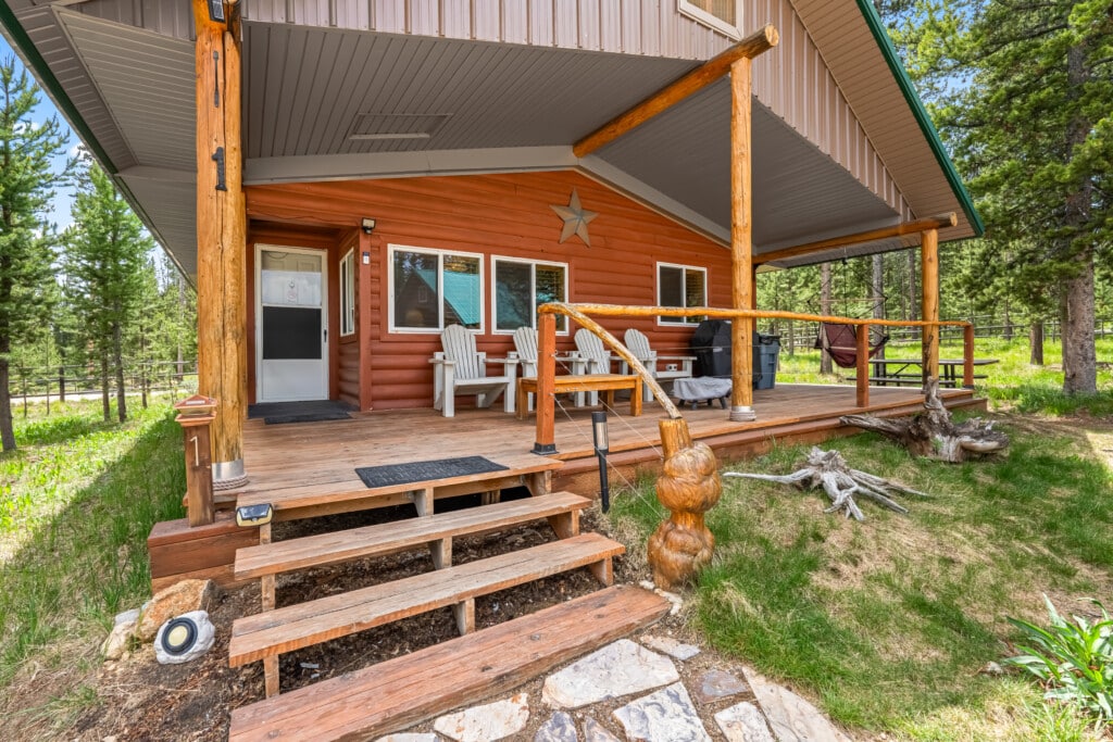 Front entrance and covered porch of Ponderosa Pine Cabin in Stanley, Idaho.