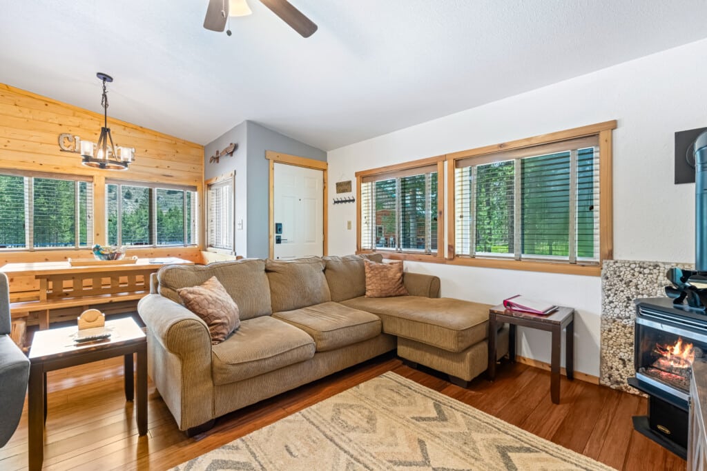 Bright living room at Bonanza Cabin with sofa and large windows.