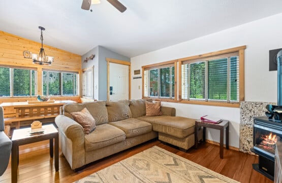 Bright living room at Bonanza Cabin with sofa and large windows.