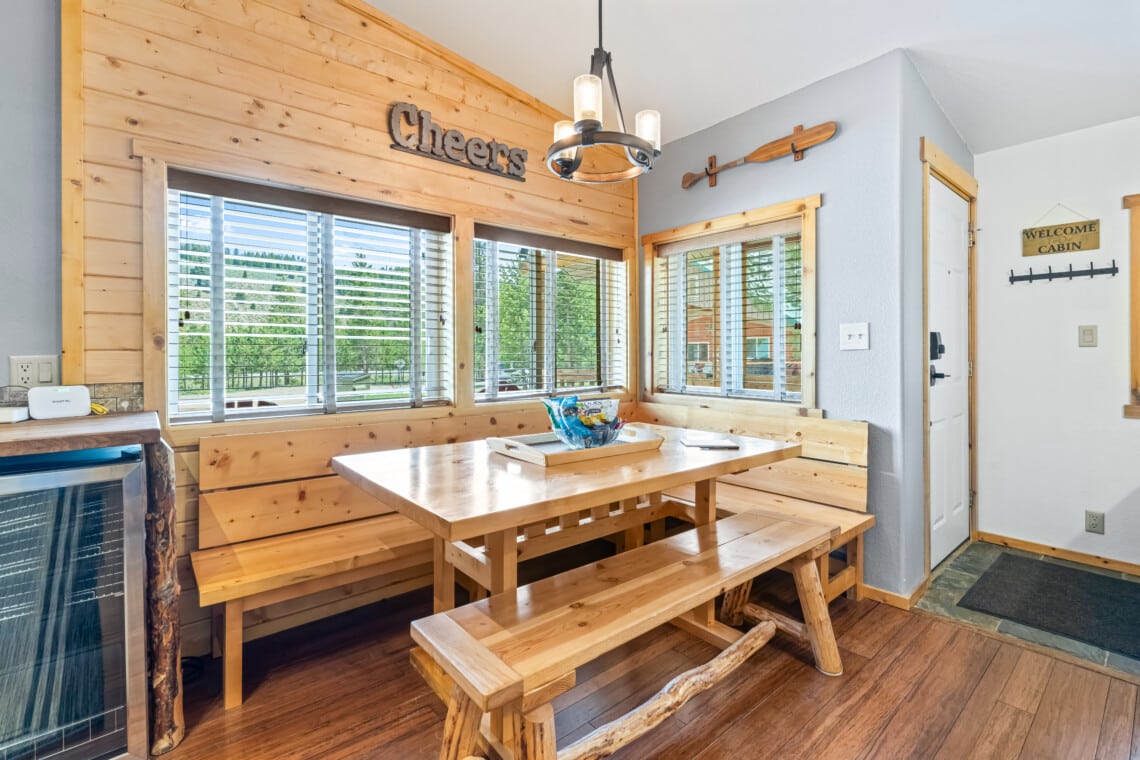 Full kitchen at Bonanza Cabin with wood cabinetry, island and stainless-steel appliances.