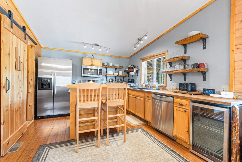 Bright living room at Bonanza Cabin with sectional sofa and large windows.