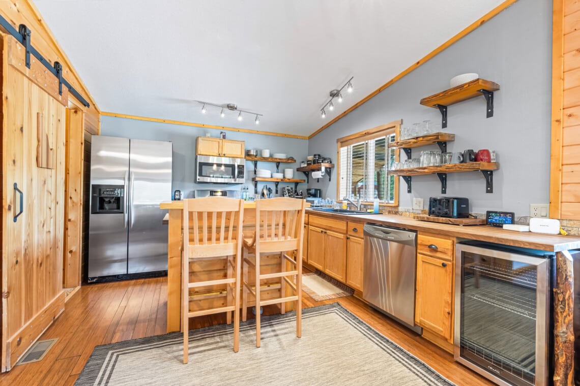 Bright living room at Bonanza Cabin with sectional sofa and large windows.