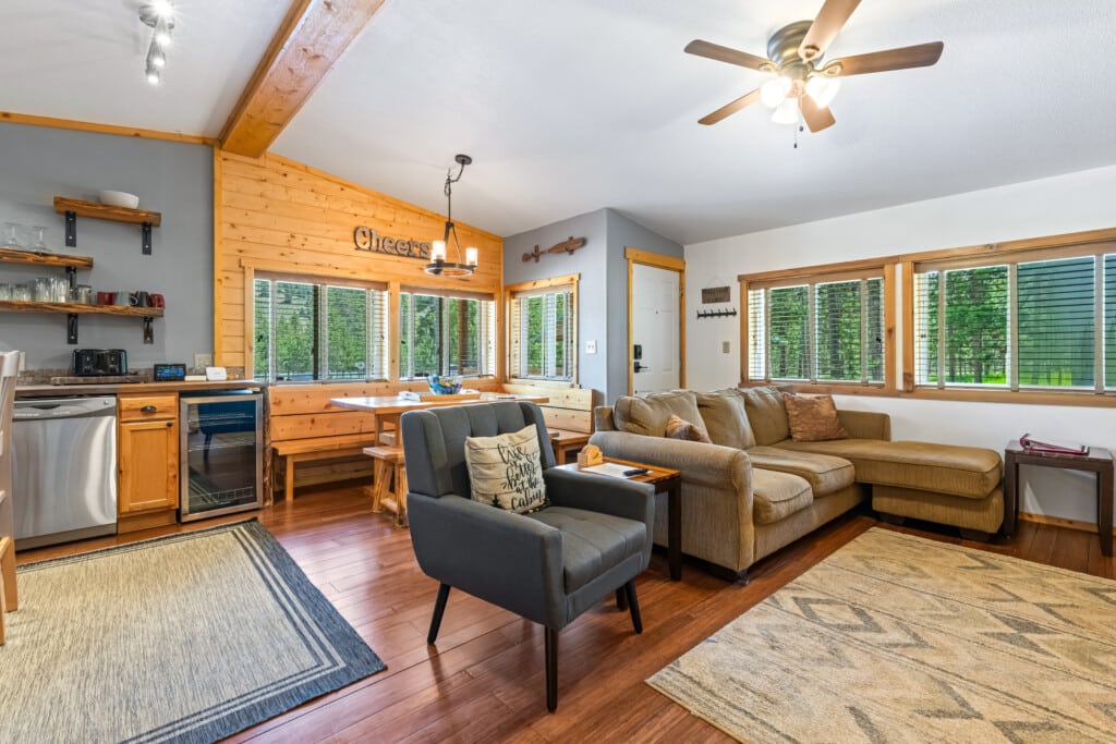 Bright living room at Bonanza Cabin with sectional sofa and large windows.
