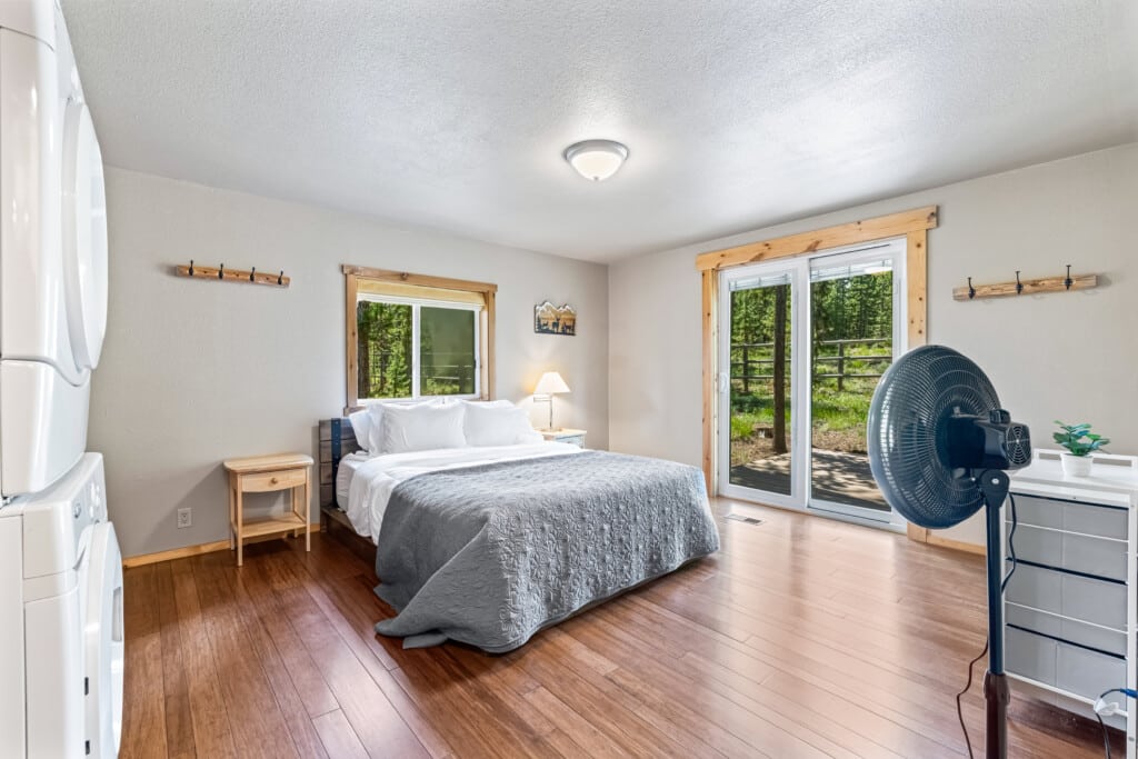 Primary bedroom at Bonanza Cabin with comfortable bed and natural light.