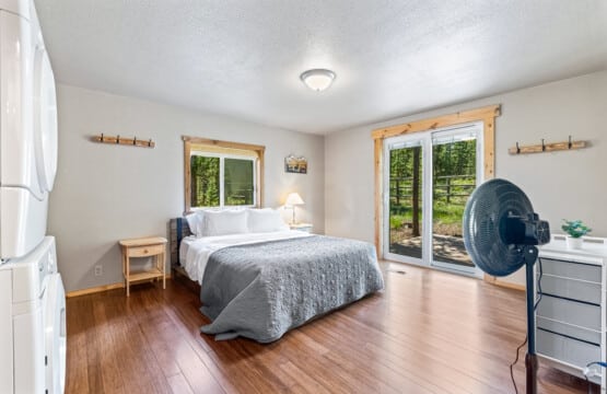 Primary bedroom at Bonanza Cabin with comfortable bed and natural light.