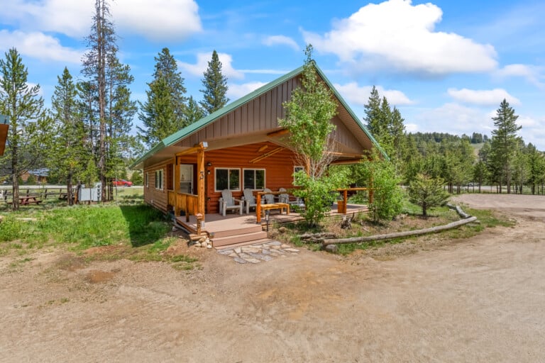 Valley Creek Cabin exterior surrounded by pine trees in Stanley, Idaho.