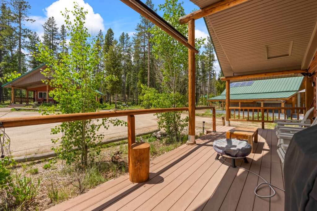 Porch Fire Pit Outdoor fire pit on the Valley Creek Cabin porch overlooking the surrounding cabins and trees.