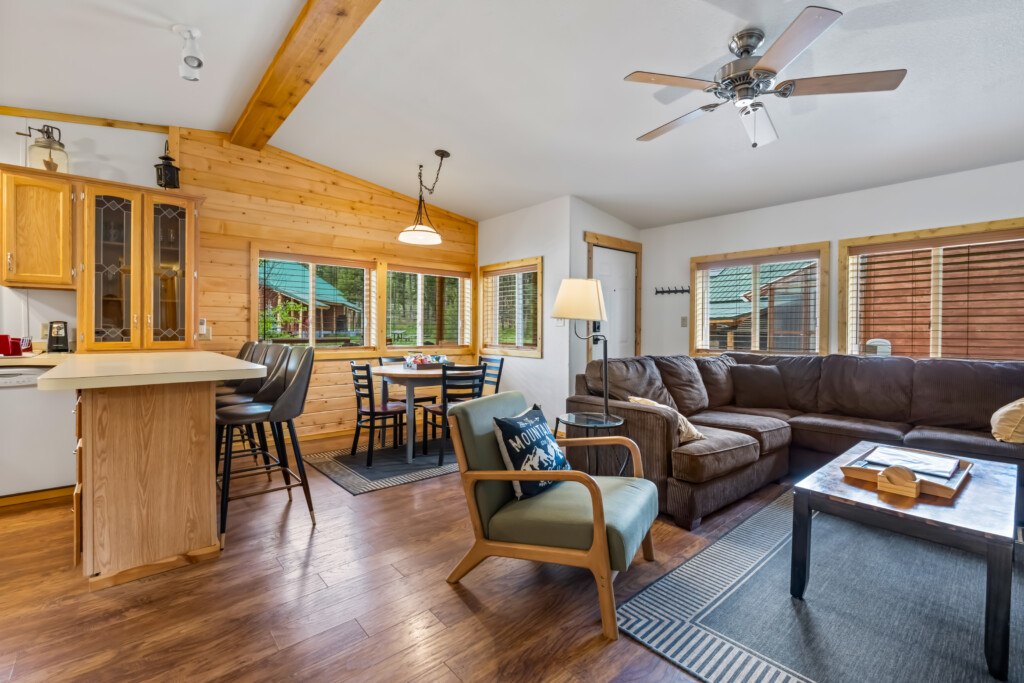 Open living area at Valley Creek Cabin with sofa, dining area and kitchen.