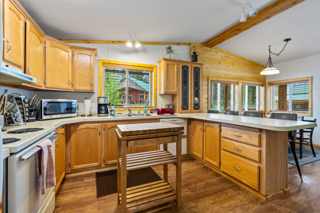 Full kitchen at Valley Creek Cabin with wood cabinets and center island.