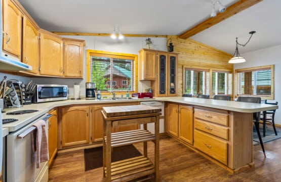 Full kitchen at Valley Creek Cabin with wood cabinets and center island.