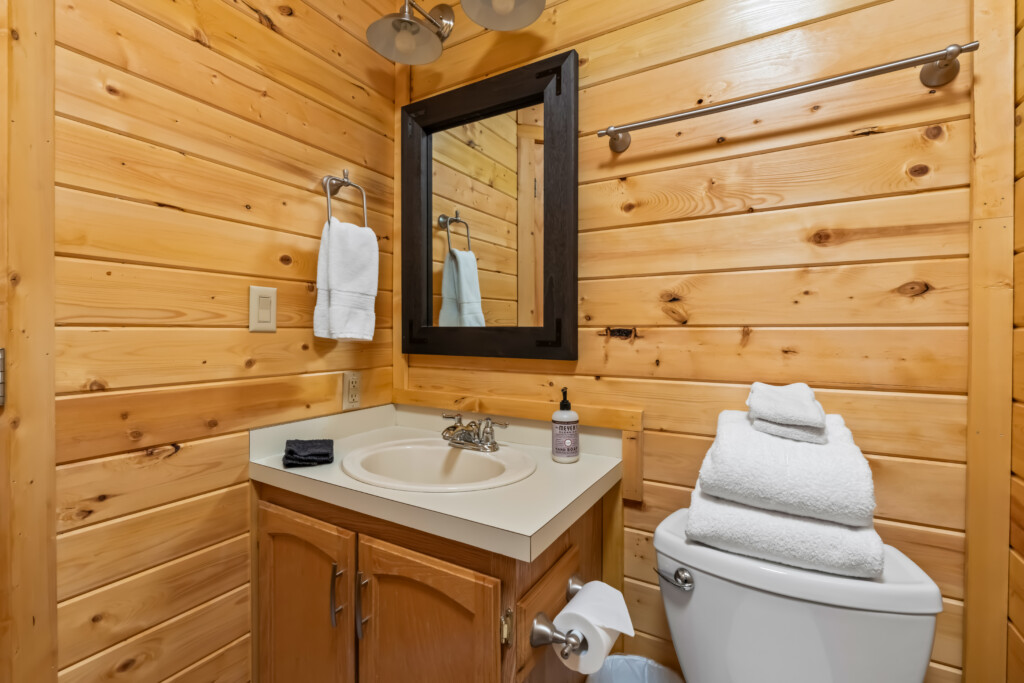 Second bathroom at Valley Creek Cabin with wood vanity, mirror and sink.
