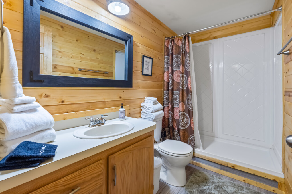 Valley Creek Cabin bathroom with vanity, mirror and shower.
