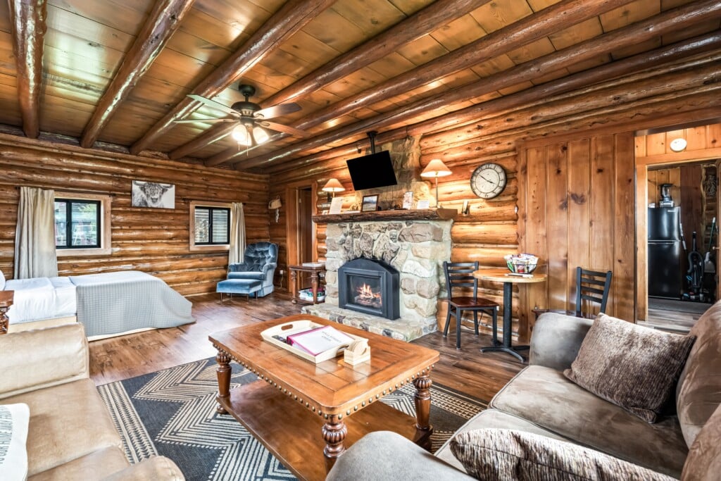 Wall Street Cabin living room facing stone fireplace