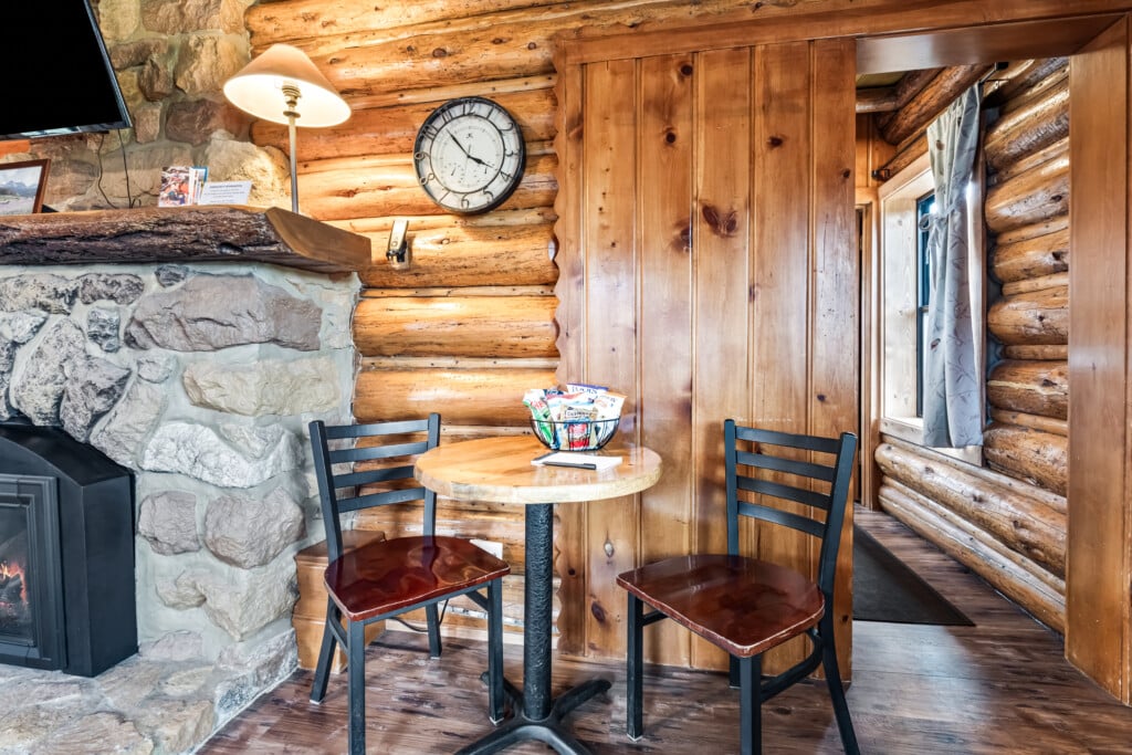 Dining table beside fireplace at Wall Street Cabin