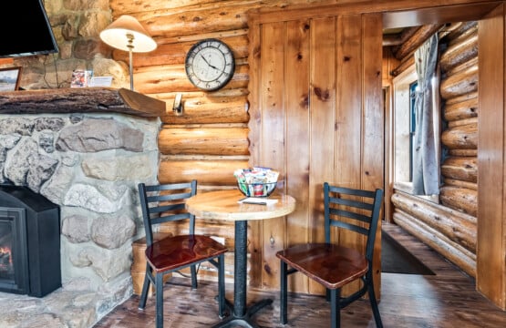 Dining table beside fireplace at Wall Street Cabin