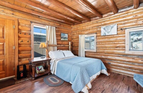 Full-size bed in Wall Street Cabin main living area